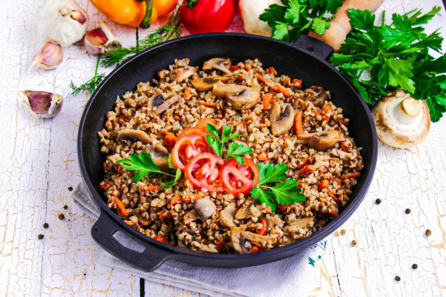 Mushrooms with buckwheat in a frying pan