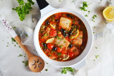 Cod stewed with vegetables in a frying pan