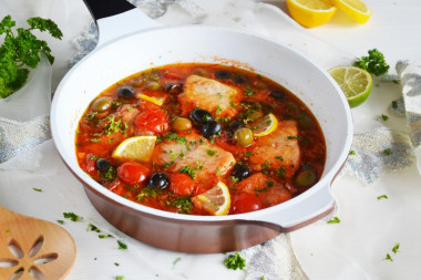 Cod stewed with vegetables in a frying pan