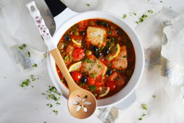 Cod stewed with vegetables in a frying pan