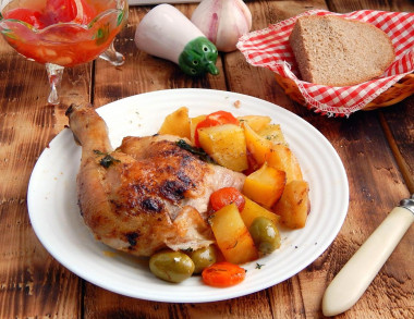 Potatoes with chicken on a baking sheet baked in the oven