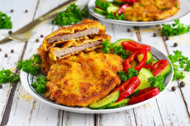 Beef schnitzel in a frying pan