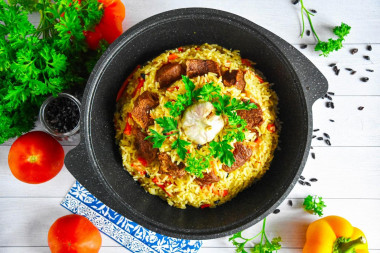 Uzbek beef pilaf in a cauldron