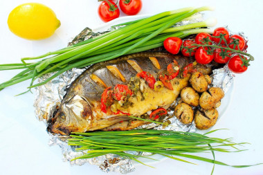 Carp in foil on coals