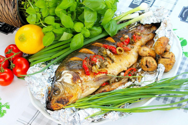 Carp in foil on coals