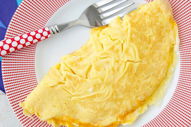 Sweet omelet with milk in a frying pan