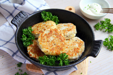 Pollock cutlets in a frying pan