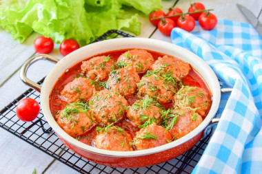 Meatballs with tomato paste gravy in a frying pan