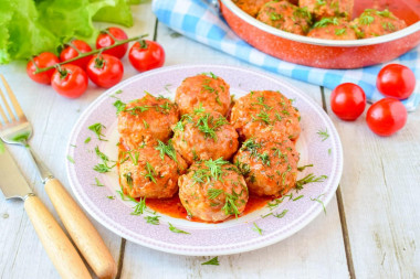 Meatballs with tomato paste gravy in a frying pan