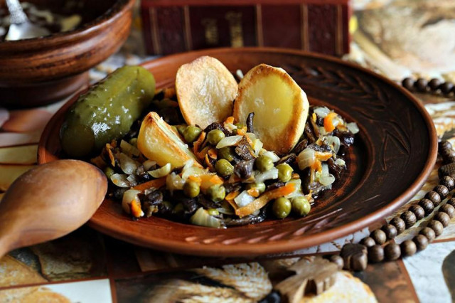 Frozen mushrooms in a frying pan with potatoes