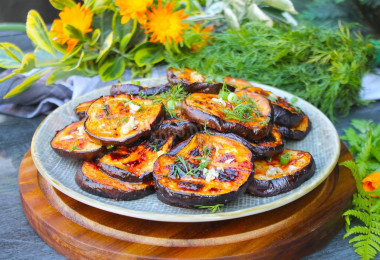 Eggplant on a grill on coals