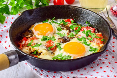 Fried eggs with mushrooms, mushrooms, tomatoes and cheese