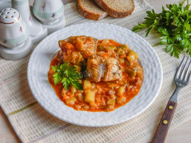 Pollock stewed with vegetables in a frying pan