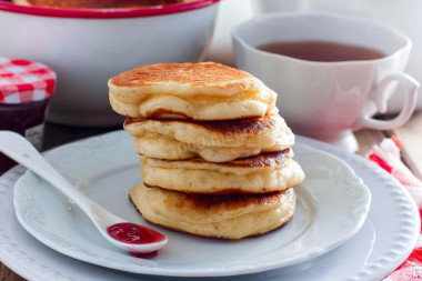 Fluffy pancakes with apples in milk