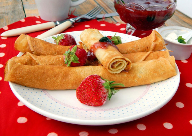 Thin grandmother's pancakes with milk