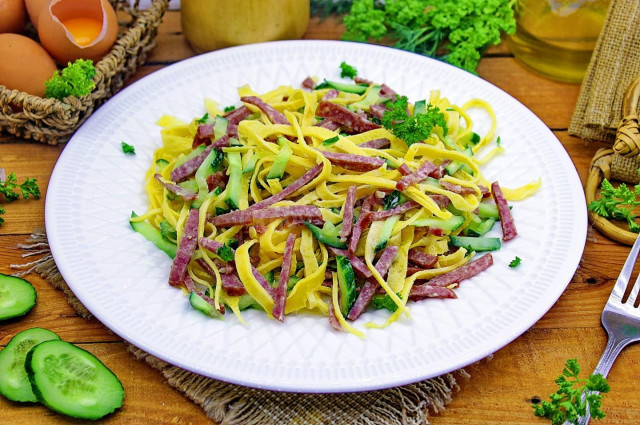 Salad with pancakes and smoked sausage