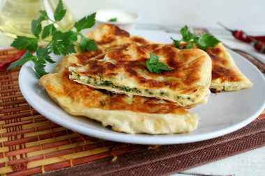 Pita bread with cottage cheese and egg in a frying pan