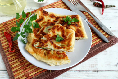 Pita bread with cottage cheese and egg in a frying pan