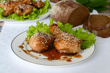 Chicken drumsticks in soy sauce on frying pan