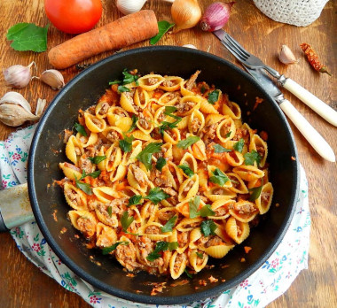 Seashells stuffed with minced meat in a frying pan