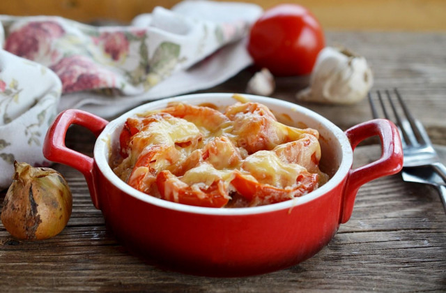 Pork belly with cheese and tomatoes in the oven