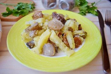 Potatoes with mushrooms in a frying pan with sour cream