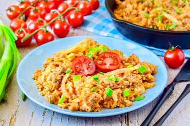 Stewed cabbage with minced meat and rice in a frying pan