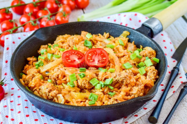 Stewed cabbage with minced meat and rice in a frying pan