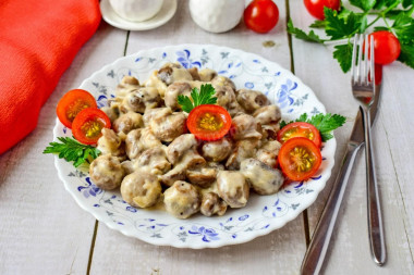 Mushrooms in cream with cheese in a frying pan