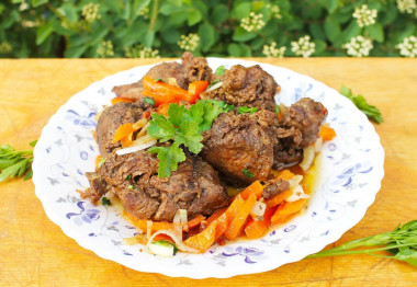 Stewed hare with vegetables and garlic in a frying pan