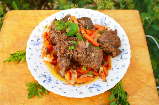 Stewed hare with vegetables and garlic in a frying pan