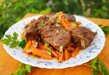 Stewed hare with vegetables and garlic in a frying pan