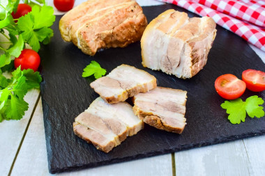 Pork belly in beer in a frying pan