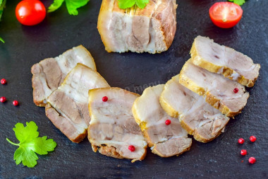 Pork belly in beer in a frying pan