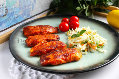 Pangasius fillet in tomato batter in a frying pan