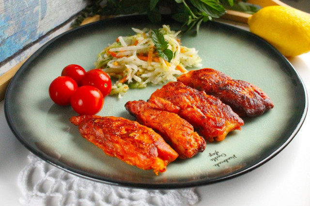 Pangasius fillet in tomato batter in a frying pan