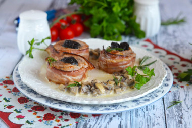 Pork tenderloin with prunes in bacon with sauce