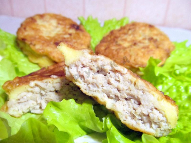 Pork cutlets in batter in a frying pan