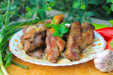 Duck in a cauldron on a fire with onions