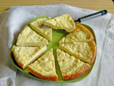 Cottage cheese casserole in a frying pan with lemon zest