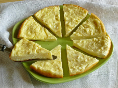 Cottage cheese casserole in a frying pan with lemon zest