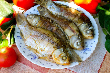 Crucian carp on coals in foil with sour cream