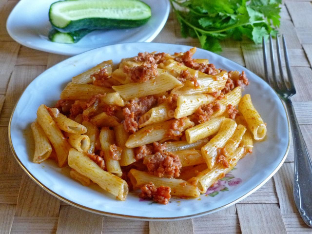 Pasta with turmeric and minced meat in a frying pan