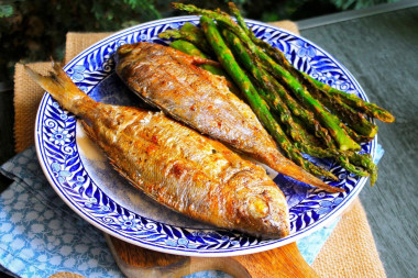 Dorada fish on coals on the grill