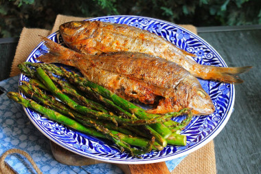 Dorada fish on coals on the grill