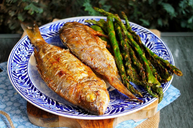 Dorada fish on coals on the grill