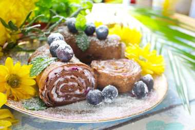 Chocolate pancake roll with cream