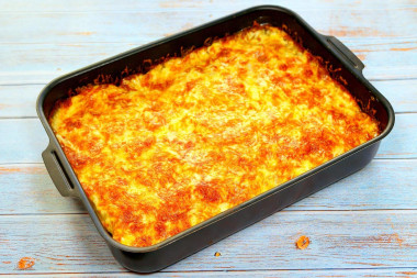 Casserole with potatoes, pork, hard cheese and onions