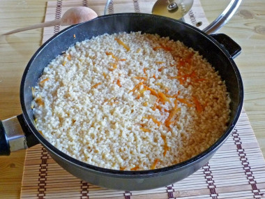 Pork pilaf in a deep frying pan