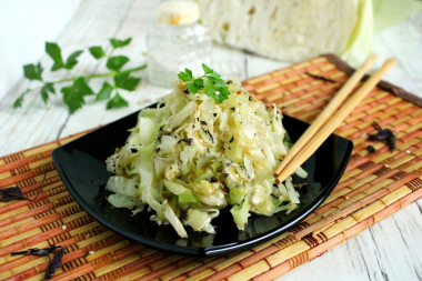 White cabbage with sesame seeds in a frying pan